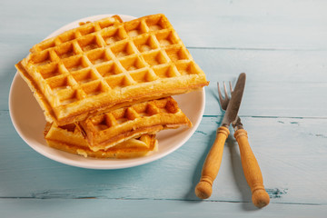 Freshly baked belgium waffles in plate. Breakfast concept