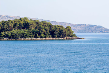 Fototapeta premium View from sea to Corfu island part. Greece, sunset.