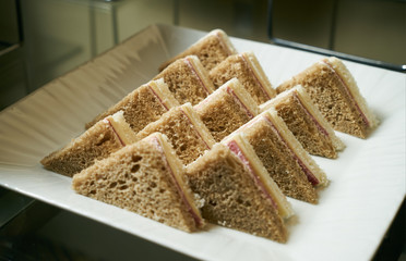 Cut platter of mixed sandwich triangles. Close-up