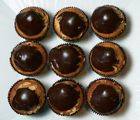 Set of tasty chocolate frosting cakes isolated on white. Top view