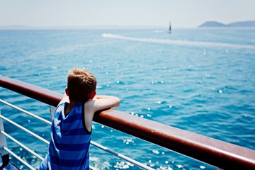Sad thoughtful little boy looking at the sea