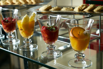 Colorful fresh fruit cocktail glass on the bar counter