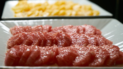 Sliced ripe grapefruits on a white plate