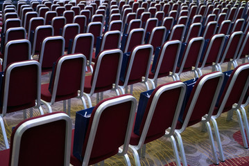 Fototapeta premium Conference room with red comfortable chairs detail and yellow floor. Horizontal