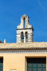Fototapeta na wymiar Old building apartments roof bells in ramshackle condition. Sky background. Greece, Corfu island