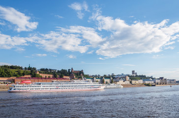 The cruise ship goes along the banks of the Volga near Nizhny Novgorod