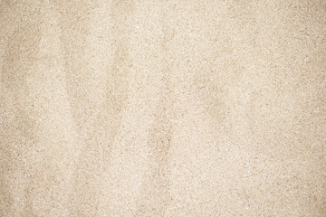 Fototapeta na wymiar Beach sand background. Beautiful texture of golden sand photographed in close-up