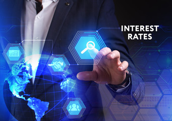 The concept of business, technology, the Internet and the network. A young entrepreneur working on a virtual screen of the future and sees the inscription: Interest rates