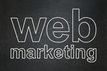 Web development concept: Web Marketing on chalkboard background