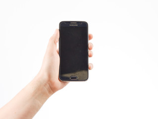 Hand holding smart phone on white background