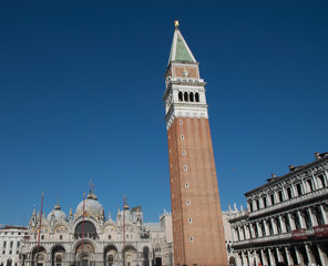 Fototapeta na wymiar Saint Mark bell tower in the center of Venice with golden angel statue at the top and beautiful clouds