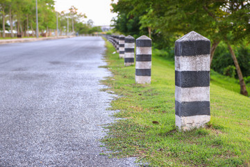 black and white painted milestone. in range roadside on white background