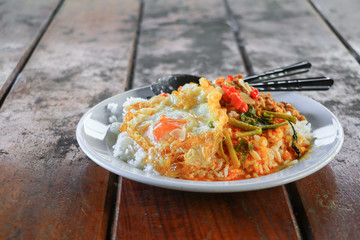Close up rice topped with chicken basil with fried egg  and curry spicy  thailand food  On wooden desk