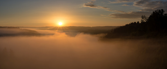 Belgian countryside - Ardennes. View over the Semois valley covered by clouds in the Belgian Ardennes in the early morning.