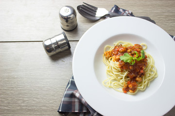 Spaghetti bolognese pasta with tomato sauce,homemade healthy italian pasta on wooden background