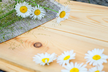 Wild flowers on wooden background