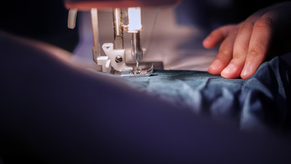 sewing a cloth in closeup 