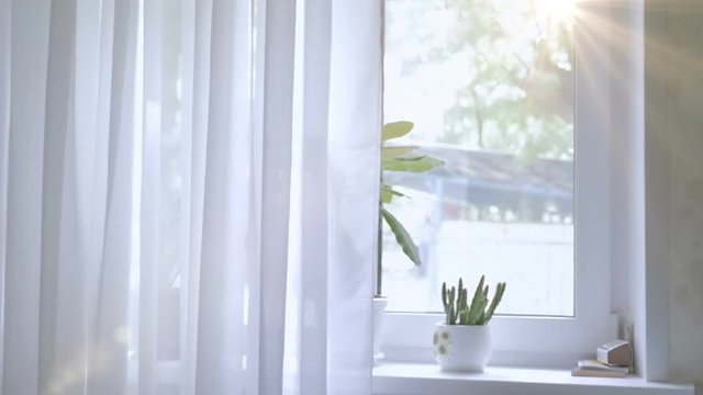 The window is white with curtains. The background