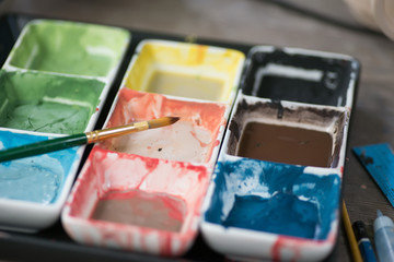 Photo of colorful and brush bright watercolor in cuvettes