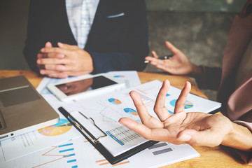 Business team meeting present. Professional investor working with new startup project. Digital tablet laptop computer design smart phone in office.