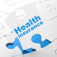 Insurance concept: Health Insurance on puzzle background