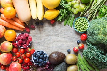 Rainbow fruits and vegetables on the grey wooden table, top view, copy space for text, selective focus © Liliya Trott
