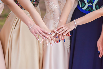 Group of girls in dresses showing their nails