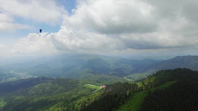 Aerial Paragliding over Mountains and Valleys