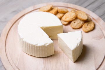 Tzfat cheese with crackers. Israeli traditional cheese. Symbol of the Jewish holiday Shavuot. Selective focus.