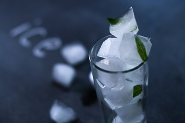 Natural ice in a glass on a black matte background.