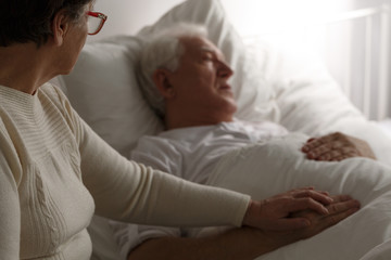 Senior man in hospital bed