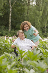 Fototapeta premium Senior woman and nurse in a garden
