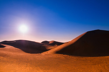 Fototapeta na wymiar Desert and sand dune before sunset