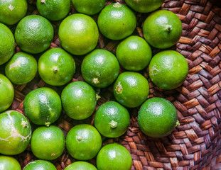 Close up limes in bamboo basket