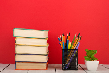 Fototapeta premium education and wisdom concept - books on wooden table, color background