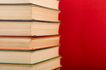 education and wisdom concept - books on wooden table, color background