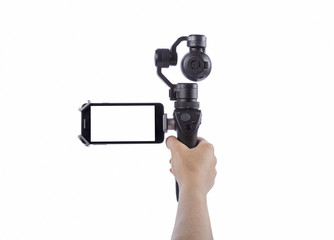 Hand holding innovative digital camera who is a new generation with electronic stabilizer. 