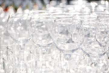Catering background. Empty wine glasses at wedding restaurant reception outdoors.