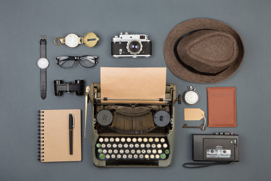 Journalist or private detective workplace - typewriter, camera, hat, recorder and other stuff