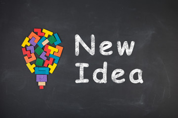 Business creative idea concept - inscription and jigsaw blocks on the blackboard