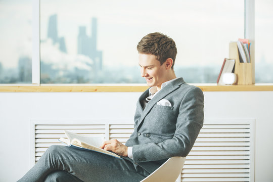 Happy Businessman Reading Book