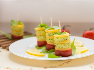 Appetizer. Canapes of cheese, cream cheese with garlic, parsley, basil, sorrel and cherry tomatoes