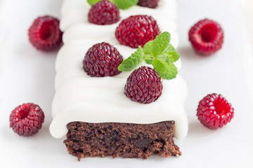 Homemade brownies with cream cheese frosting and raspberry