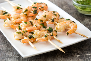 Shrimp skewers on wooden table
