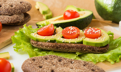 Healthy food. Avocado Sandwich with Cherry Tomatoes and Lettuce