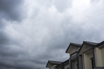 Storm clouds background with home