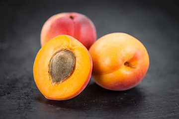 Plakat Rustic slate slab with Fresh Apricots (selective focus)