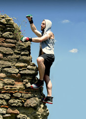 Traveler climbing to the top of Mountain ruins