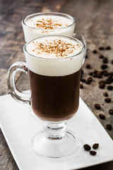 Irish coffee in glass on wooden table
