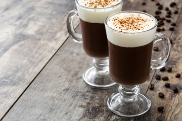 Irish coffee in glass on wooden table
